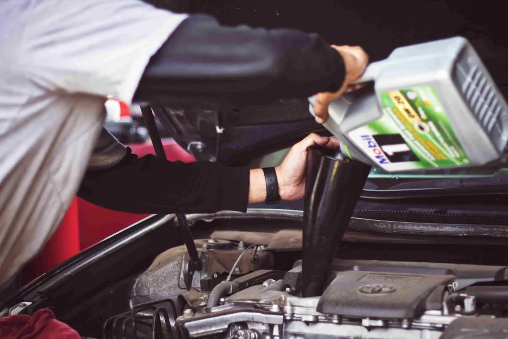 Mechanic installing car suspension component